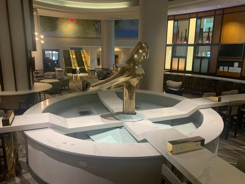 Curved quartz bar with bronze sculpture